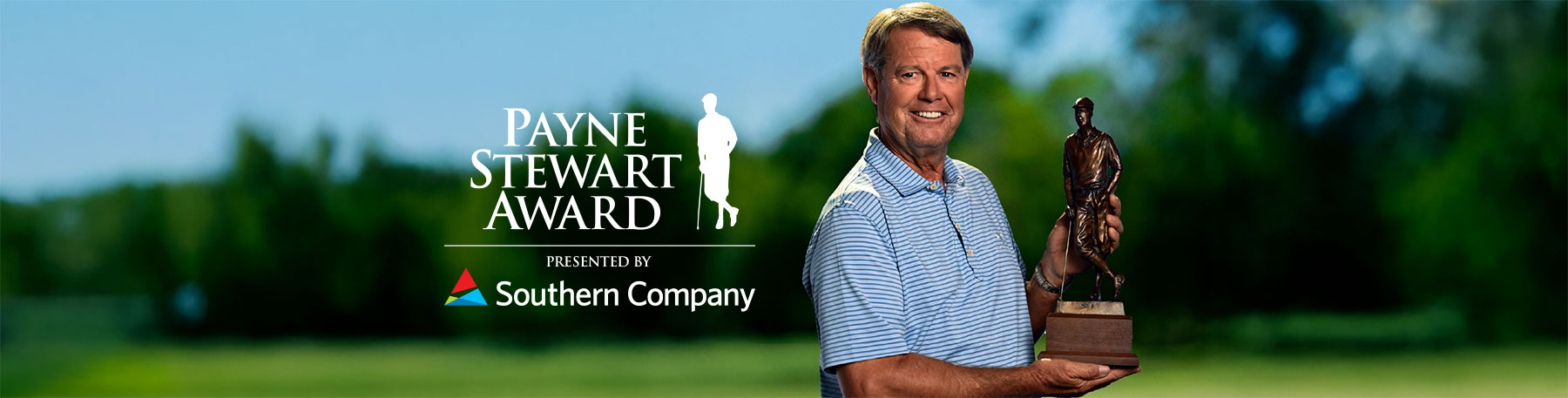 Paul Azinger posing with Payne Stewart Award trophy